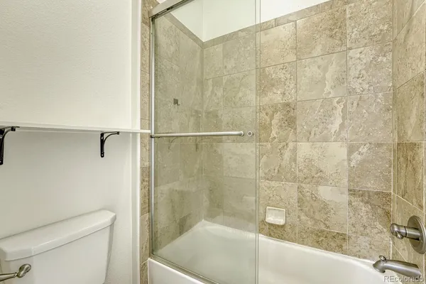 a bathroom with a shower and a toilet