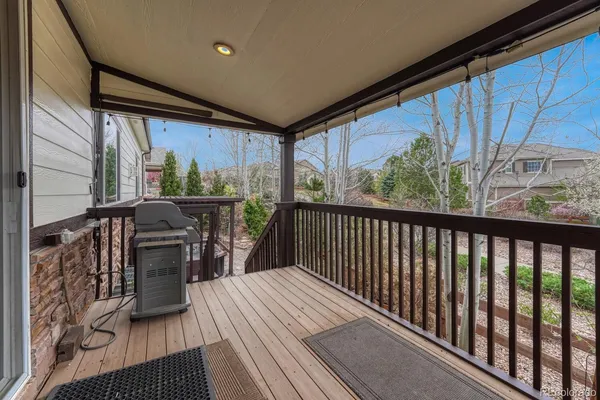 a view of a patio with chairs and potted plants