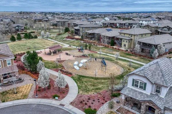 an aerial view of a house with a garden and lake view