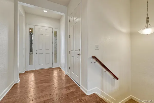 a view of a hallway with wooden floor