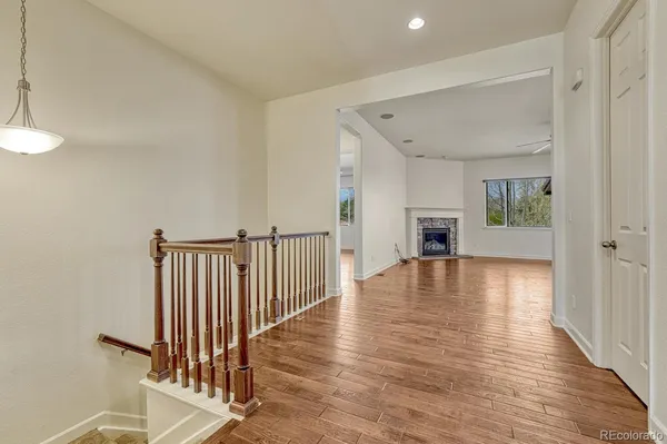 a view of a livingroom with wooden floor and a floor to ceiling window