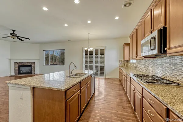 a kitchen with sink stove and cabinets