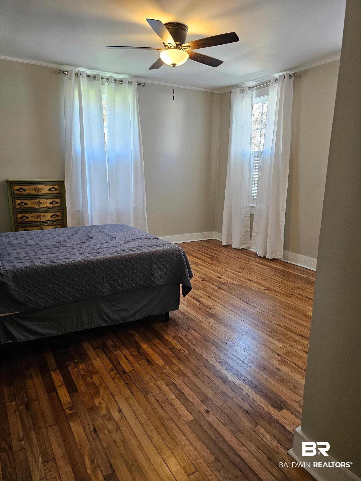 1215 Church Street Mobile, AL 36604 - Photo 13 of 23 Bedroom with baseboards, wood finished floors, a ceiling fan, and crown molding