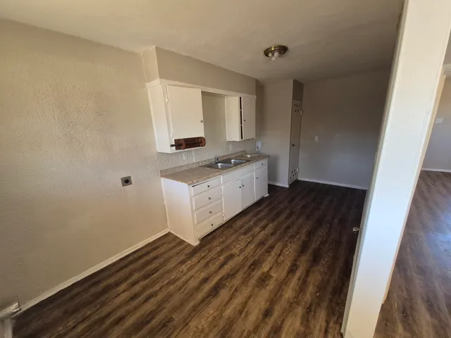a kitchen with a sink and a stove top oven