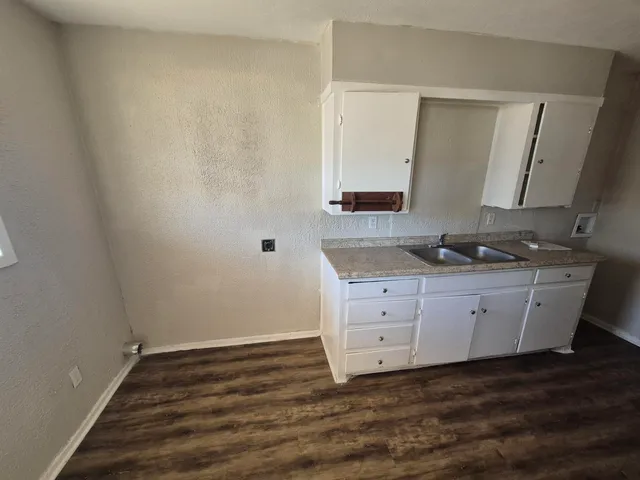 a room with cabinet and mirror