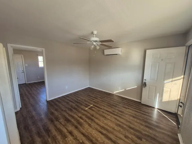 wooden floor in an empty room with a window