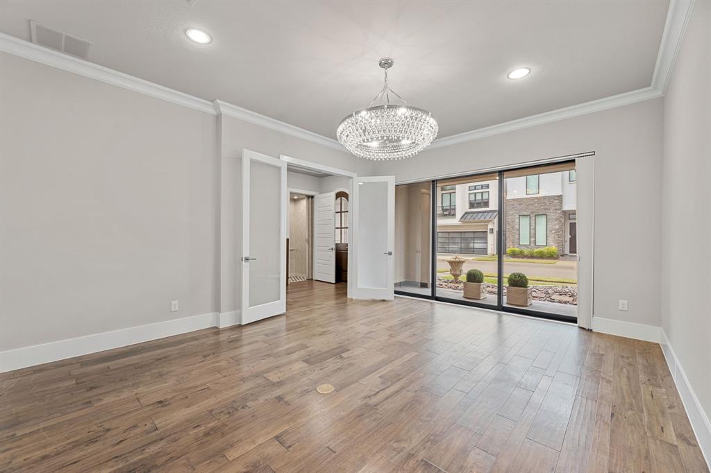 7854 Element Avenue Plano, TX 75024 - Photo 13 of 38 Unfurnished office or bedroom with wood finished floors, crown molding, recessed lighting, and a chandelier. access to patio