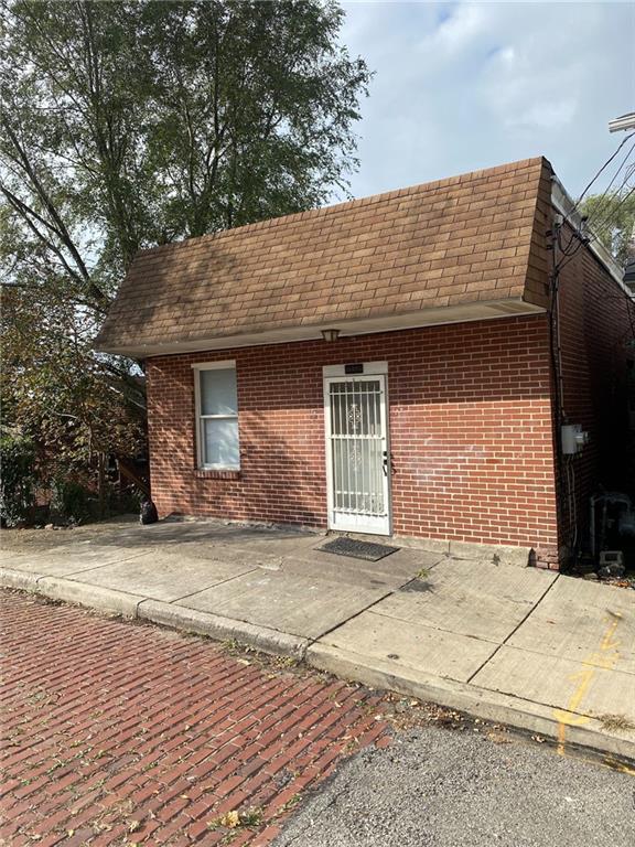 107 Overbrook Boulevard Pittsburgh, PA 15210 - Photo 2 of 21 a front view of a house with a yard and garage