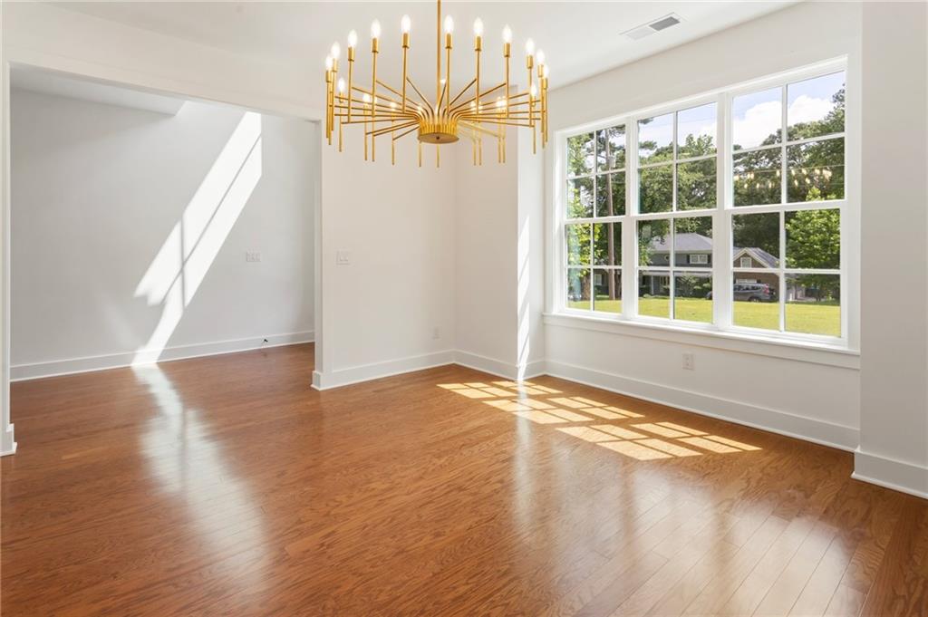 3711 Mountain Cove Road Snellville, GA 30039 - Photo 14 of 78 an empty room with wooden floor and windows