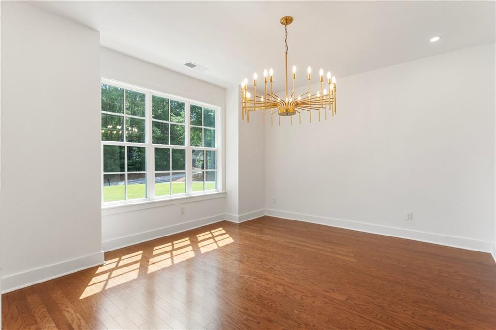 3711 Mountain Cove Road Snellville, GA 30039 - Photo 15 of 78 a view of empty room with wooden floor and windows