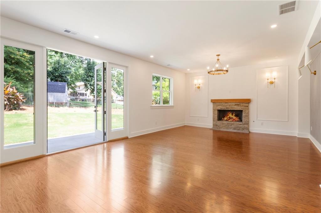 3711 Mountain Cove Road Snellville, GA 30039 - Photo 17 of 78 a view of an empty room with a window and wooden floor