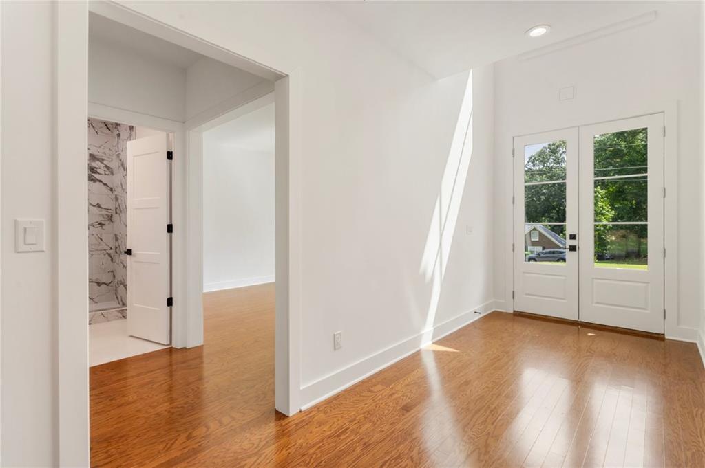 3711 Mountain Cove Road Snellville, GA 30039 - Photo 18 of 78 wooden floor in an empty room with a window