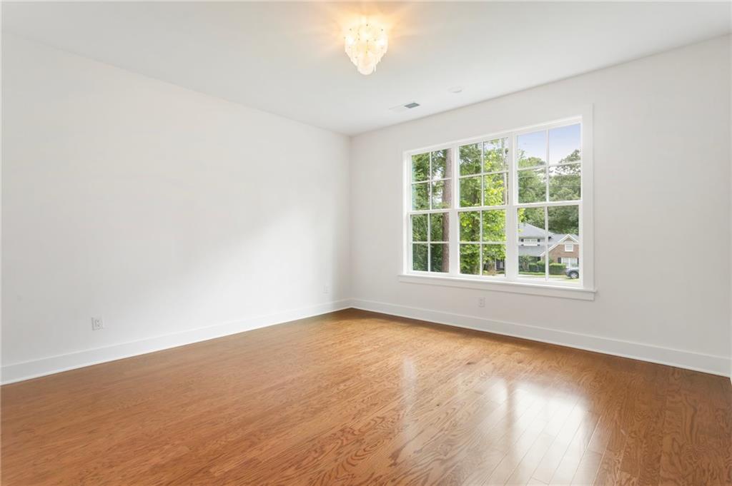 3711 Mountain Cove Road Snellville, GA 30039 - Photo 20 of 78 an empty room with wooden floor and windows