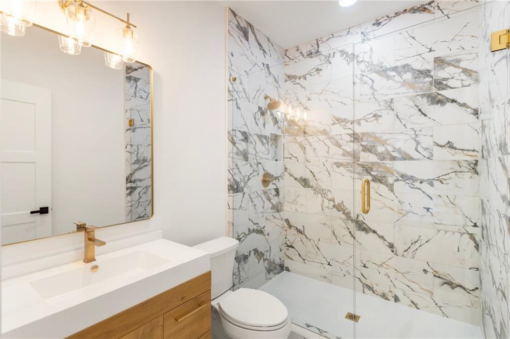 3711 Mountain Cove Road Snellville, GA 30039 - Photo 22 of 78 a bathroom with a sink and a toilet
