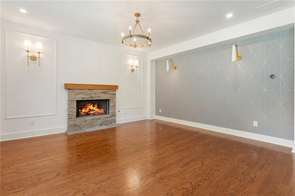 3711 Mountain Cove Road Snellville, GA 30039 - Photo 27 of 78 a view of an empty room with wooden floor and a fireplace
