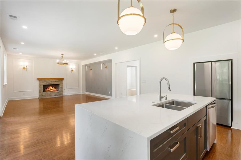 3711 Mountain Cove Road Snellville, GA 30039 - Photo 32 of 78 a kitchen with sink refrigerator and fireplace