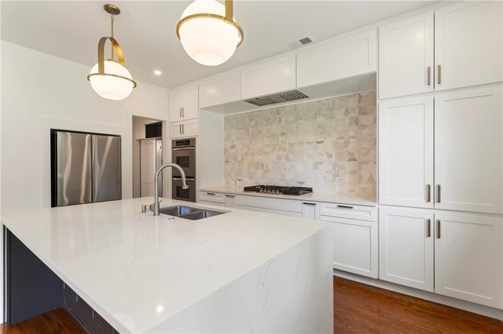 3711 Mountain Cove Road Snellville, GA 30039 - Photo 38 of 78 a kitchen with stainless steel appliances granite countertop a sink a stove and a refrigerator