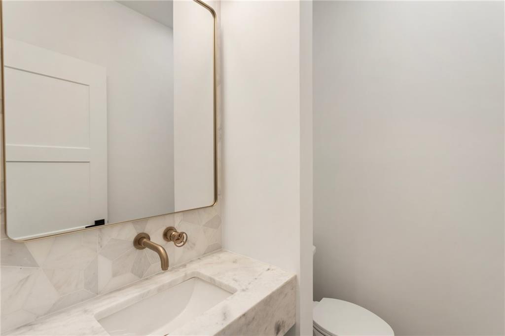 3711 Mountain Cove Road Snellville, GA 30039 - Photo 42 of 78 a bathroom with a sink and toilet