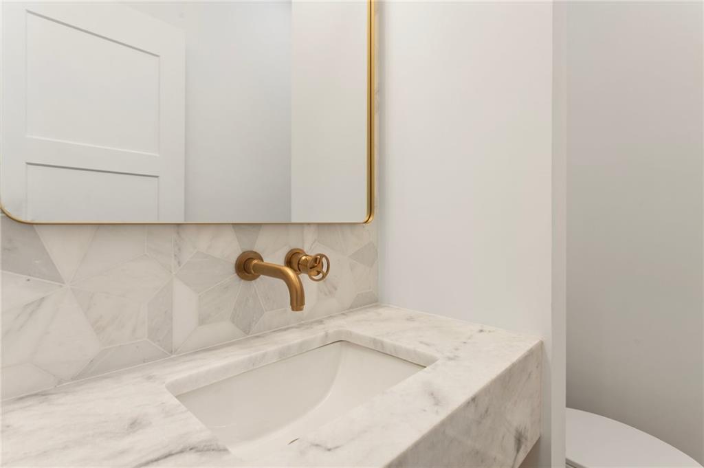 3711 Mountain Cove Road Snellville, GA 30039 - Photo 43 of 78 a bathroom with a sink and a window
