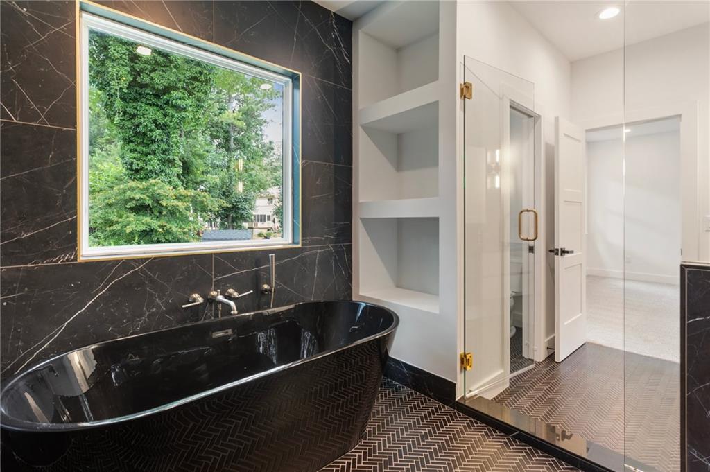 3711 Mountain Cove Road Snellville, GA 30039 - Photo 52 of 78 a bath tub sitting in a bathroom next to a window