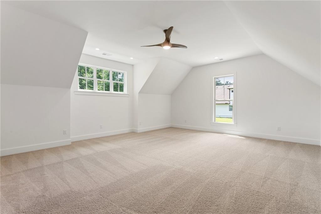 3711 Mountain Cove Road Snellville, GA 30039 - Photo 60 of 78 an empty room with windows and ceiling fan view