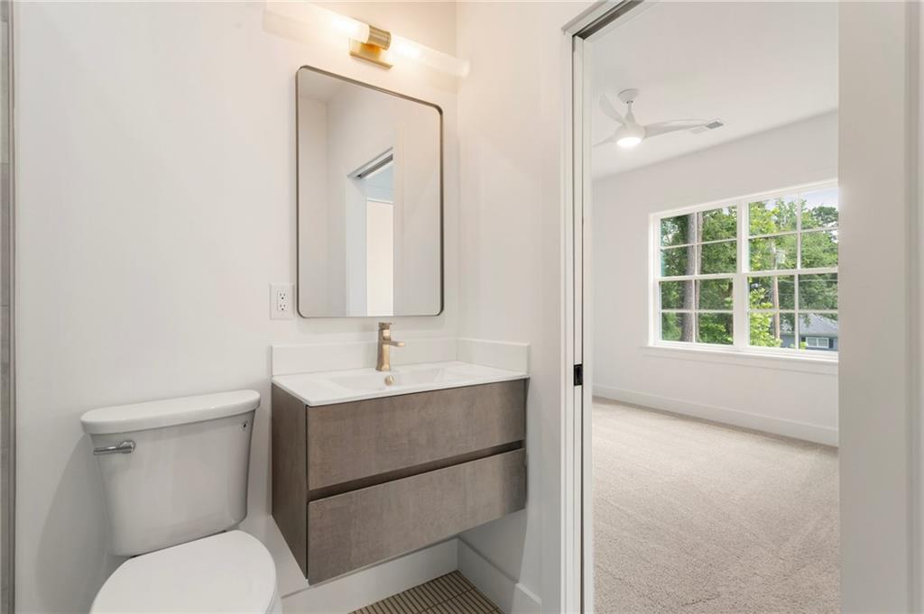 3711 Mountain Cove Road Snellville, GA 30039 - Photo 67 of 78 a bathroom with a toilet sink and mirror