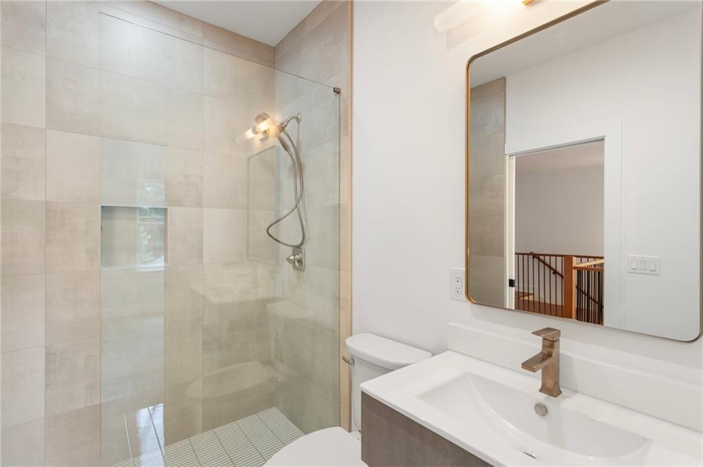 3711 Mountain Cove Road Snellville, GA 30039 - Photo 69 of 78 a bathroom with a sink shower and a mirror