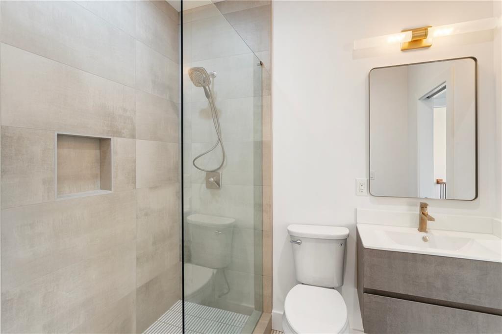 3711 Mountain Cove Road Snellville, GA 30039 - Photo 70 of 78 a bathroom with a toilet sink and shower