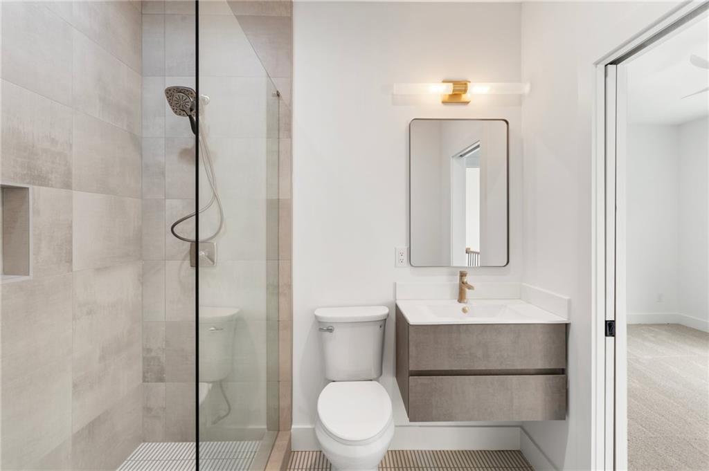 3711 Mountain Cove Road Snellville, GA 30039 - Photo 71 of 78 a bathroom with a toilet sink and shower