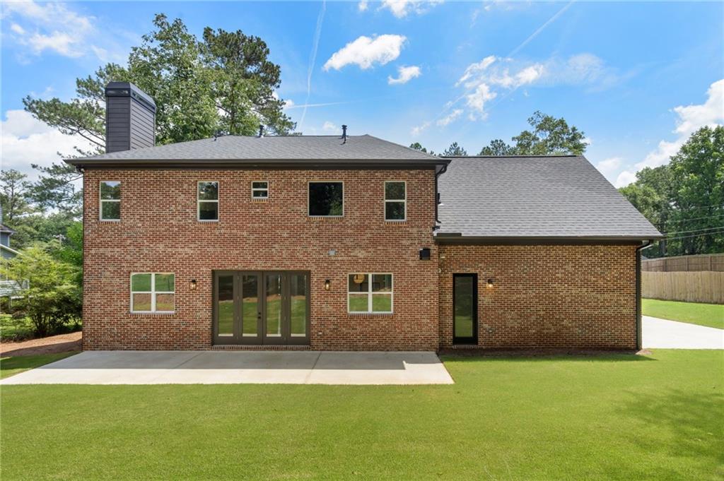3711 Mountain Cove Road Snellville, GA 30039 - Photo 77 of 78 a front view of a house with a garden and yard