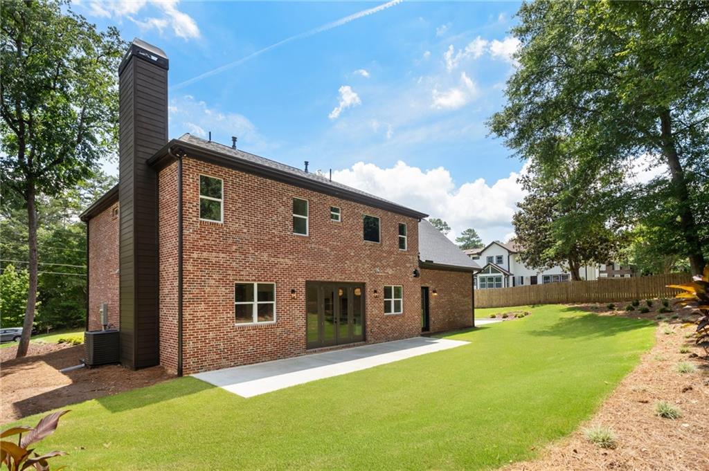 3711 Mountain Cove Road Snellville, GA 30039 - Photo 78 of 78 a front view of house with yard and trees in the background