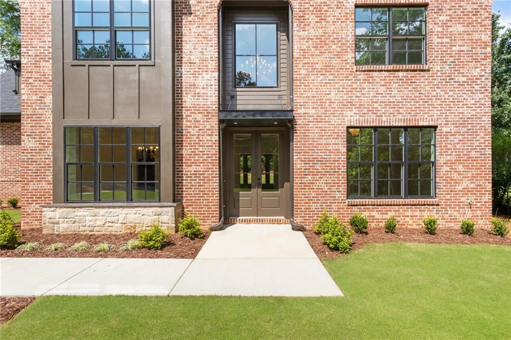 3711 Mountain Cove Road Snellville, GA 30039 - Photo 8 of 78 front view of a brick house with a yard