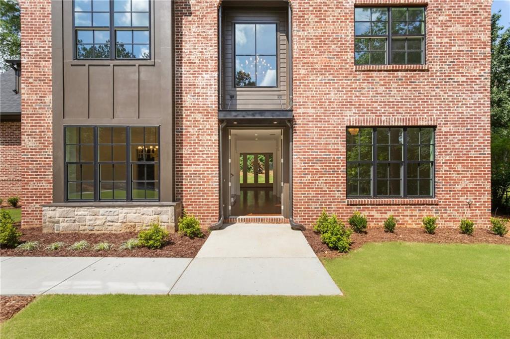 3711 Mountain Cove Road Snellville, GA 30039 - Photo 9 of 78 front view of a brick house