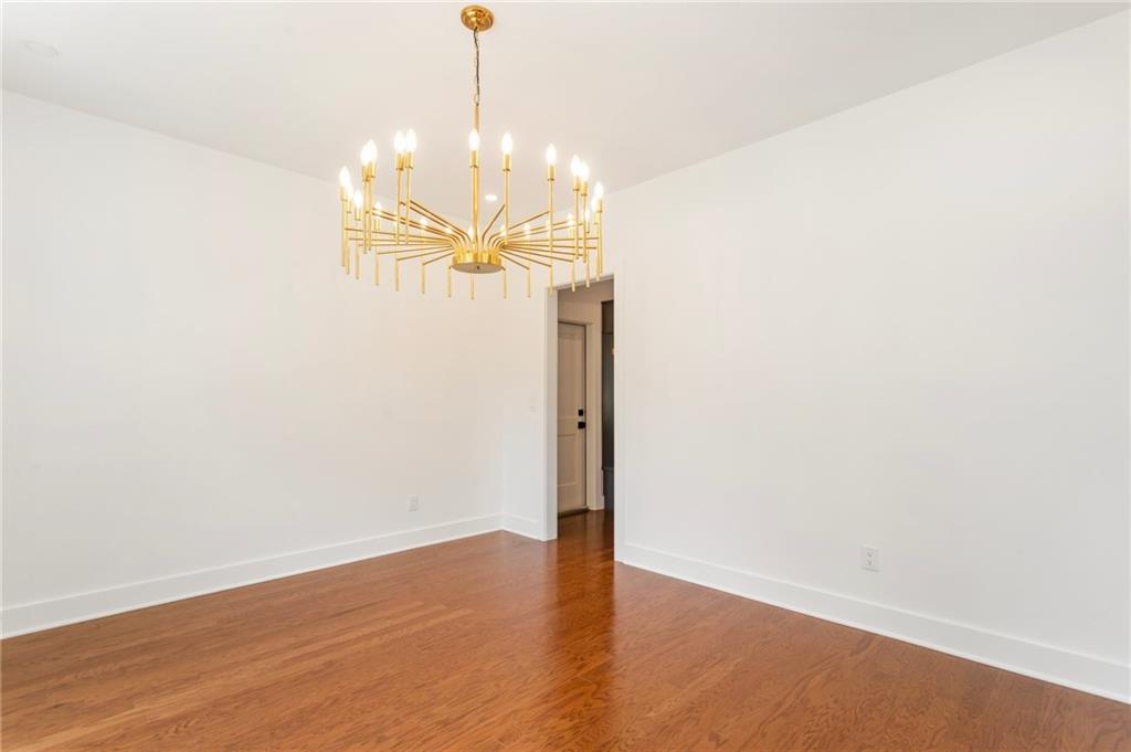 3711 Mountain Cove Road Snellville, GA 30039 - Photo 10 of 78 a view of a room with wooden floor and chandelier