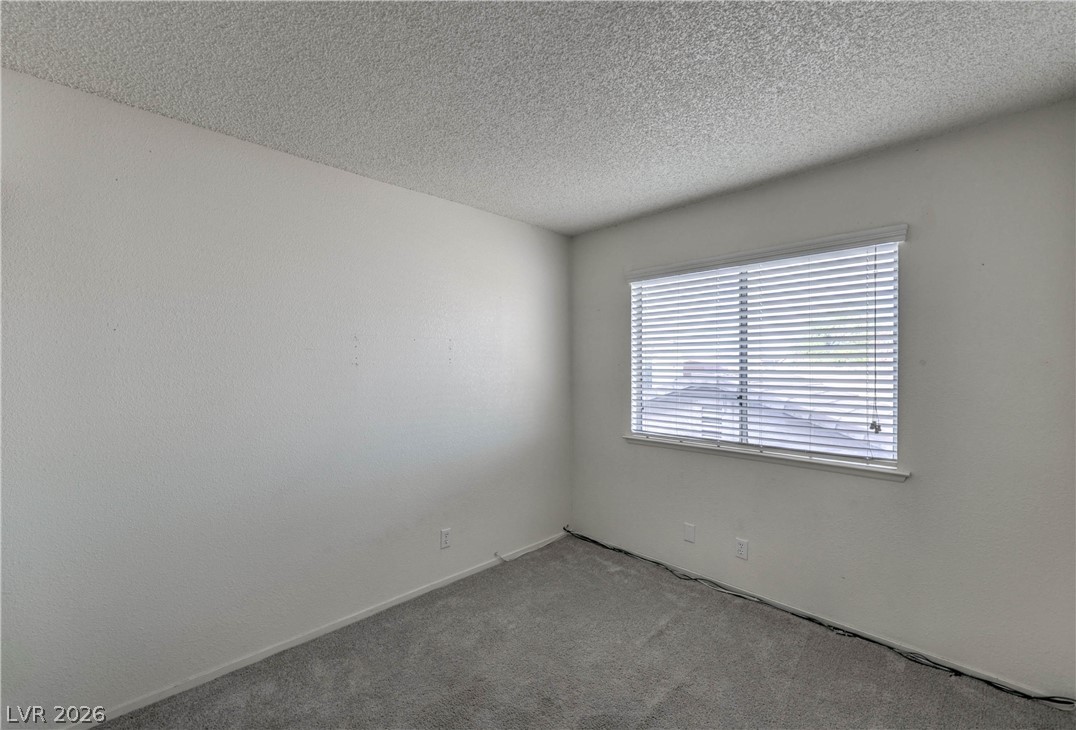 581 Carleton Drive Henderson, NV 89014 - Photo 17 of 37 A well-lit, neutral-toned room featuring a single window with blinds, ready for personalization.