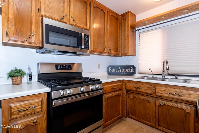 a kitchen with a sink and wooden cabinets