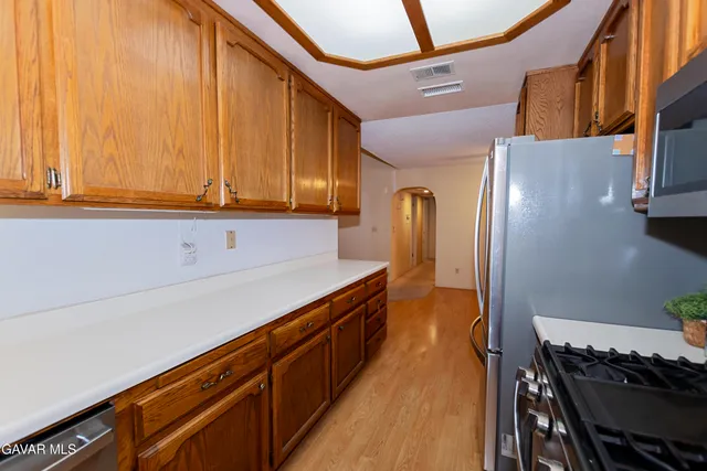 a kitchen with stainless steel appliances granite countertop a stove and a refrigerator