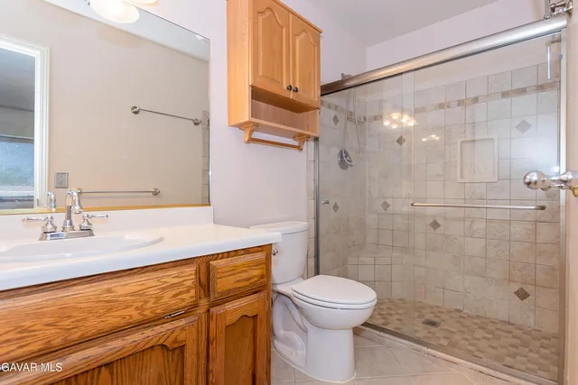 a bathroom with a sink mirror vanity and toilet