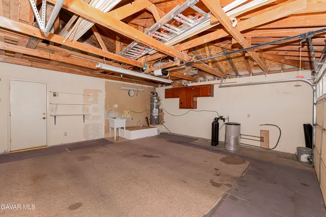 a view of a hallway with wooden floor and cabinet