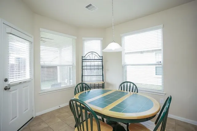 a view of a a dining room with furniture window and wooden floor