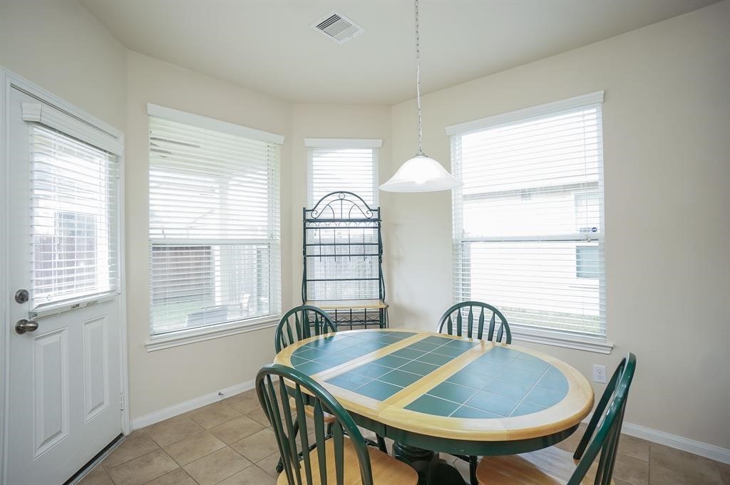 25015 Diamond Ranch Drive Katy, TX 77494 - Photo 11 of 27 a view of a a dining room with furniture window and wooden floor