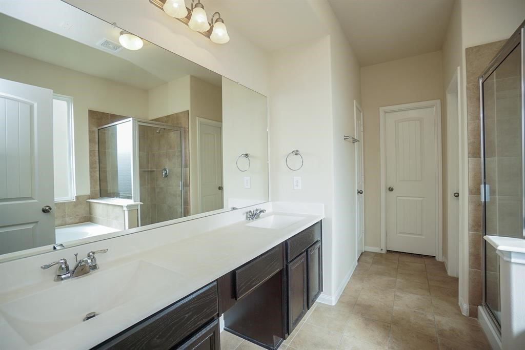 25015 Diamond Ranch Drive Katy, TX 77494 - Photo 15 of 27 a spacious bathroom with a double vanity sink a mirror and a shower