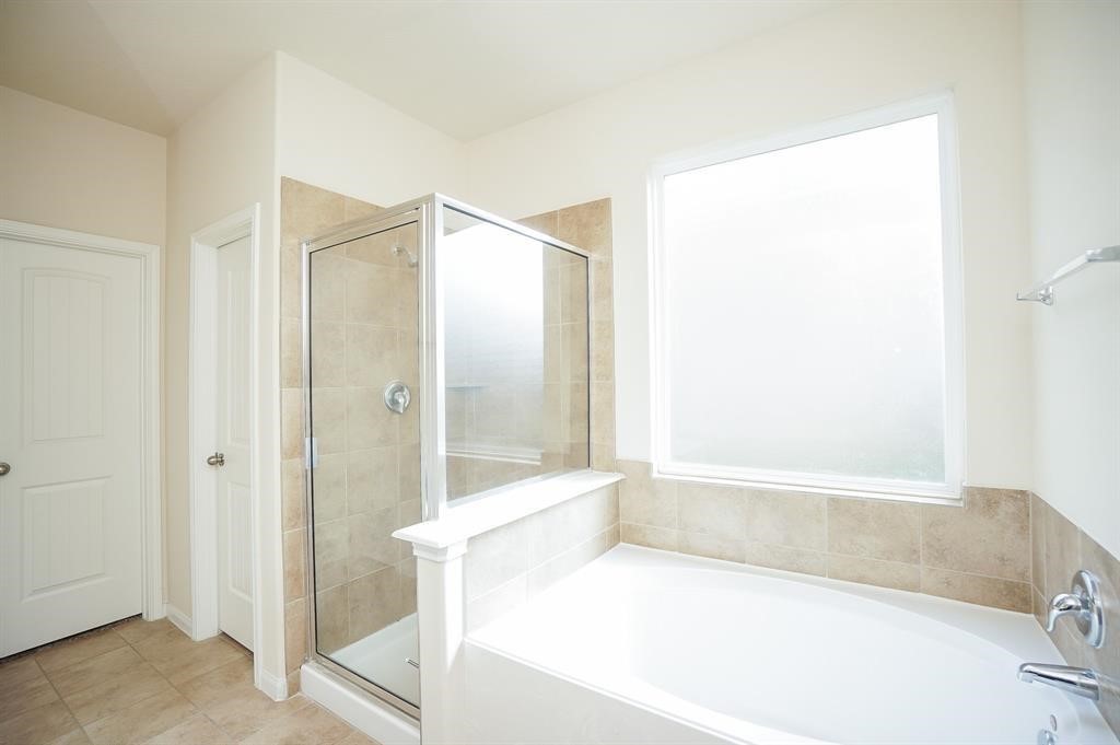 25015 Diamond Ranch Drive Katy, TX 77494 - Photo 16 of 27 a bathroom with a bathtub and a shower