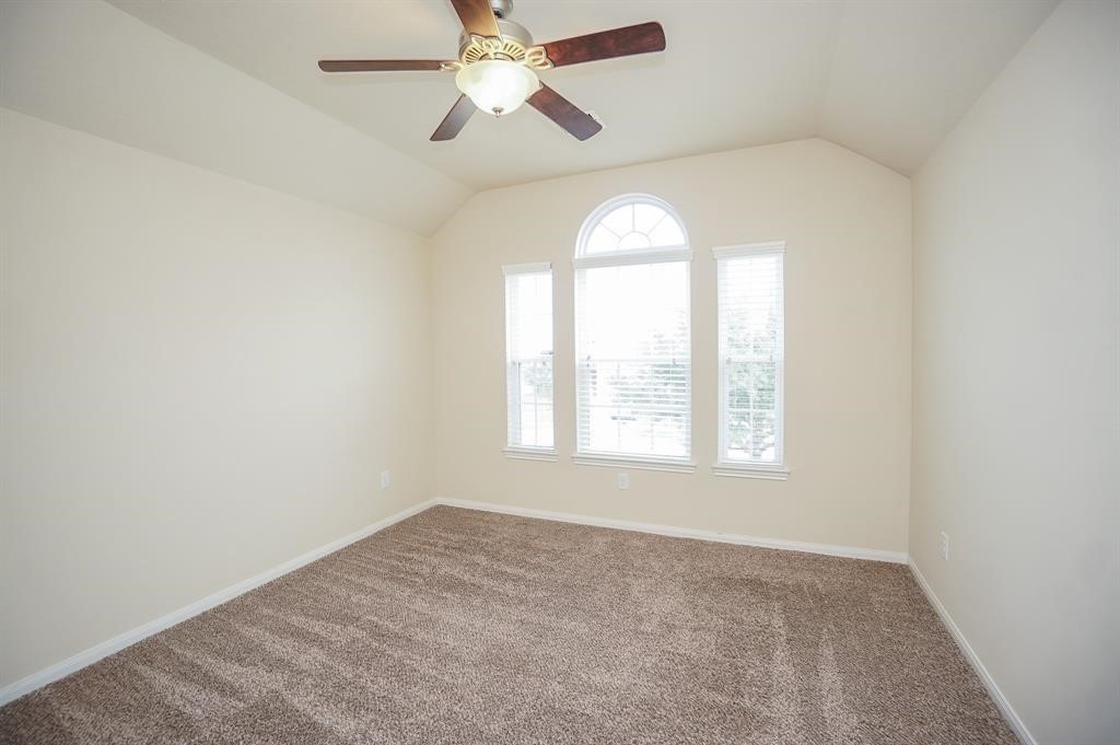 25015 Diamond Ranch Drive Katy, TX 77494 - Photo 19 of 27 an empty room with a window and a fan