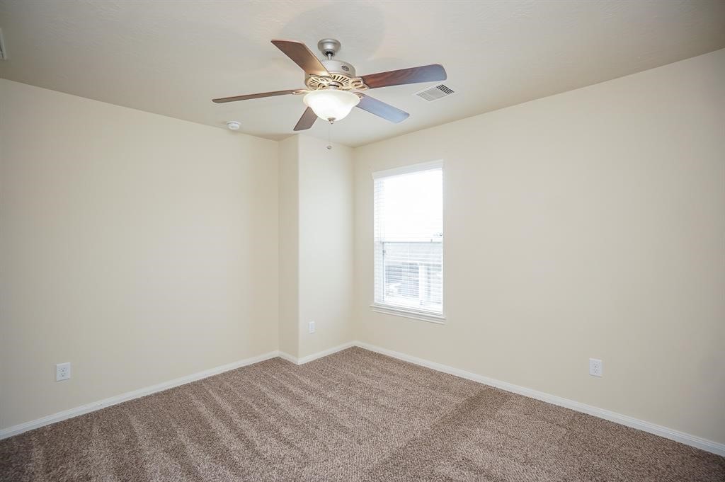 25015 Diamond Ranch Drive Katy, TX 77494 - Photo 20 of 27 an empty room with windows and fan
