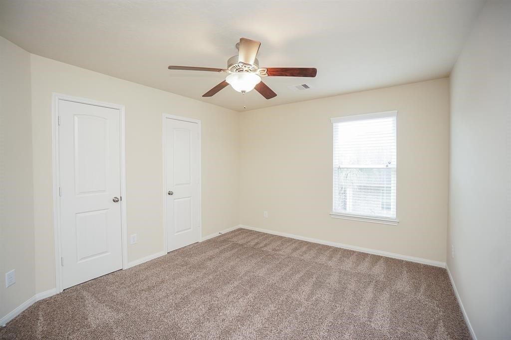 25015 Diamond Ranch Drive Katy, TX 77494 - Photo 21 of 27 an empty room with windows and fan