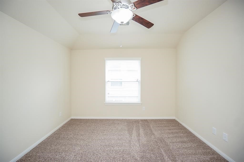 25015 Diamond Ranch Drive Katy, TX 77494 - Photo 22 of 27 an empty room with a chandelier fan and windows