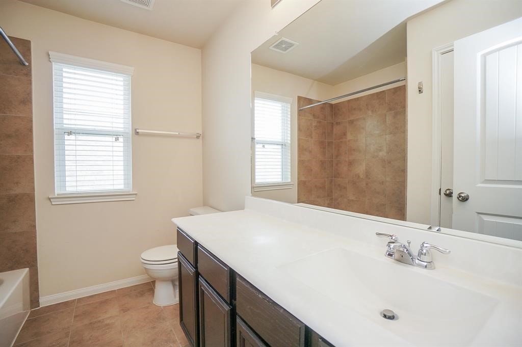 25015 Diamond Ranch Drive Katy, TX 77494 - Photo 23 of 27 a bathroom with a sink and a mirror