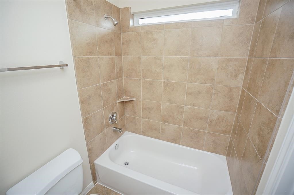 25015 Diamond Ranch Drive Katy, TX 77494 - Photo 24 of 27 a bathroom with a bathtub and toilet
