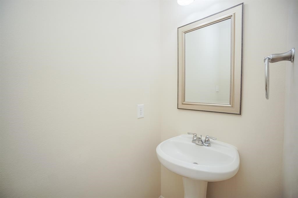25015 Diamond Ranch Drive Katy, TX 77494 - Photo 25 of 27 a bathroom with a sink and a mirror